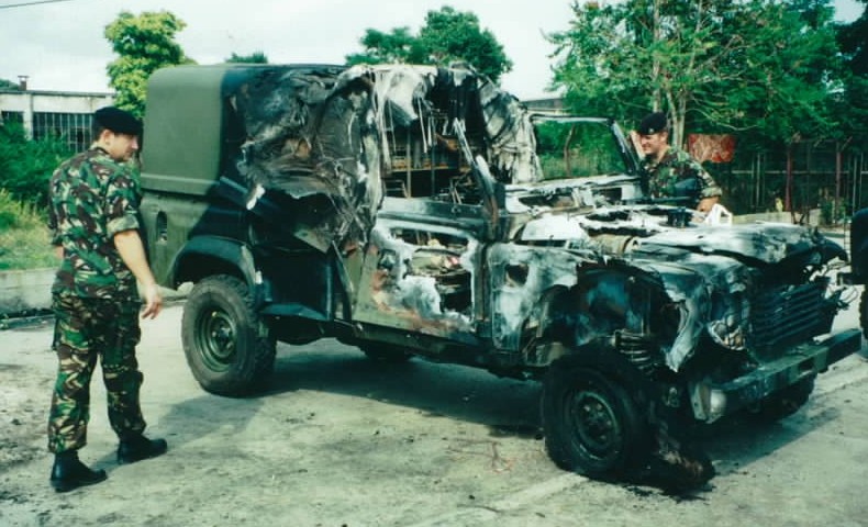 British troops examine a Landrover blown up by a bomb in Skopje before NATO entered Kosovo